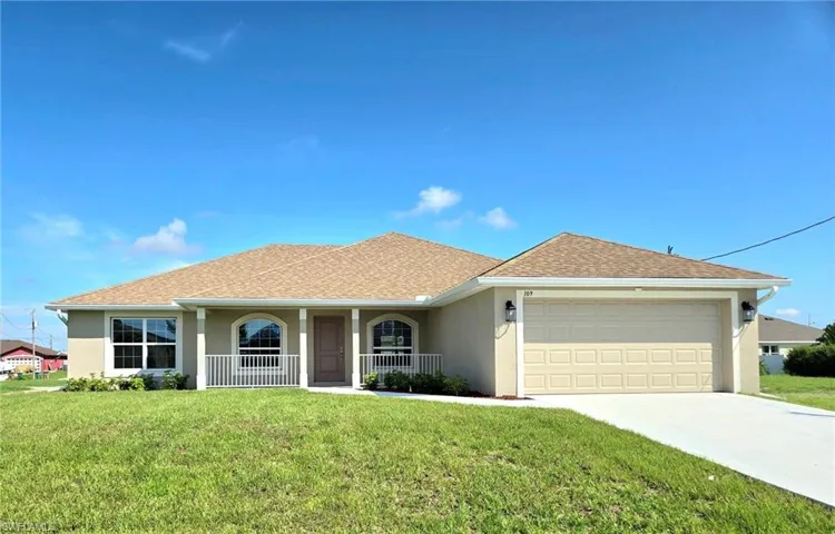 Single story home with a front yard, a garage, and a porch