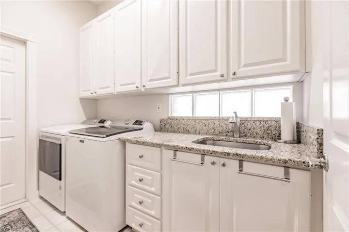 Laundry has valuable storage space and large sink.