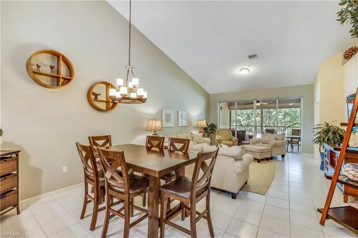 Dining and Living area with tile floors and vaulted ceilings