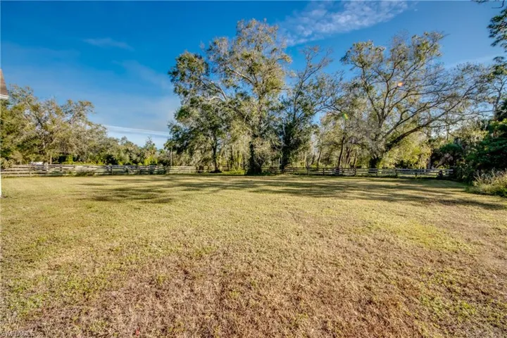View of HUGE yard featuring a view of yard with plenty of room for another structure, barn, stables