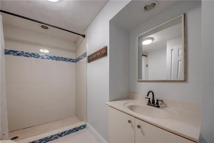 Bathroom with vanity and a shower stall