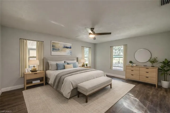 Virtually staged Bedroom with dark wood-type flooring and ceiling fan