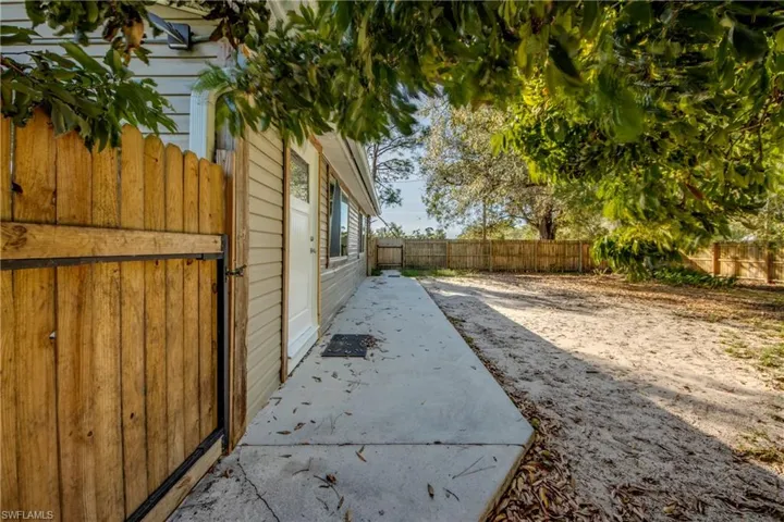 Fenced side yard with separate entrance with a patio area