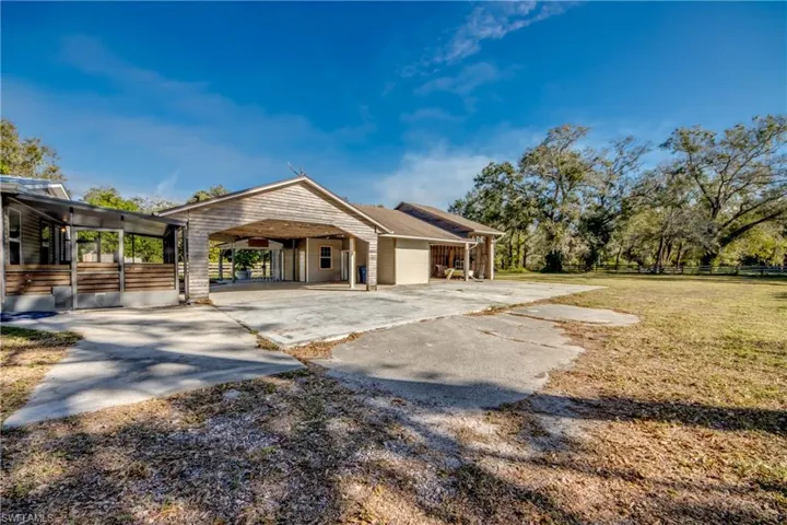 View of home's exterior with concrete driveway and a carport