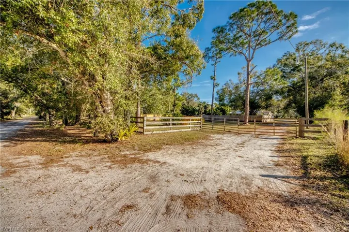 View of street with a view of countryside and gated entrance