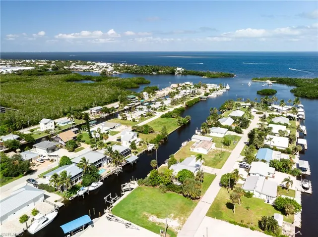 Aerial view of residential area featuring a nearby body of water