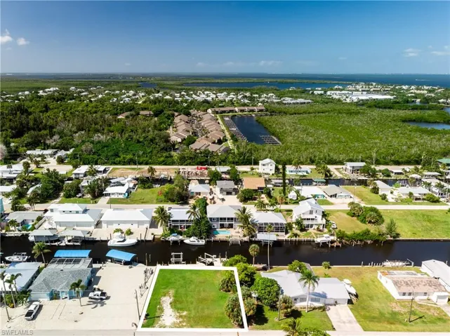 Aerial view of residential area featuring a nearby body of water