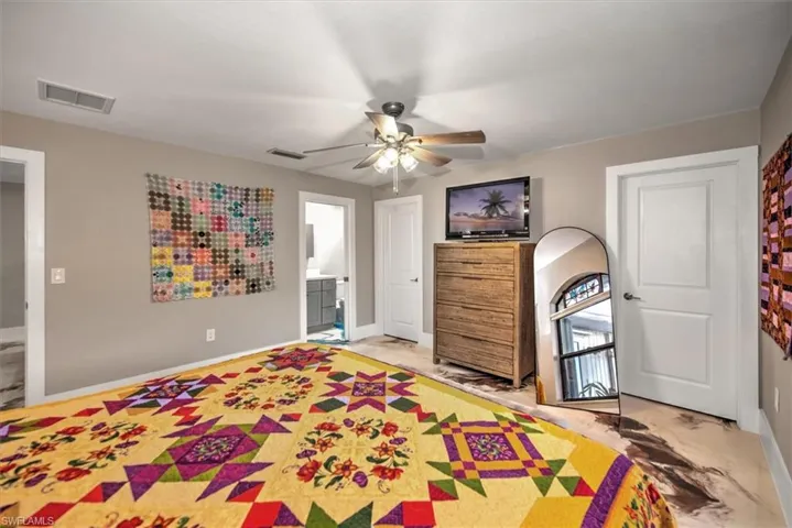 Bedroom featuring visible vents, baseboards, and ensuite bath