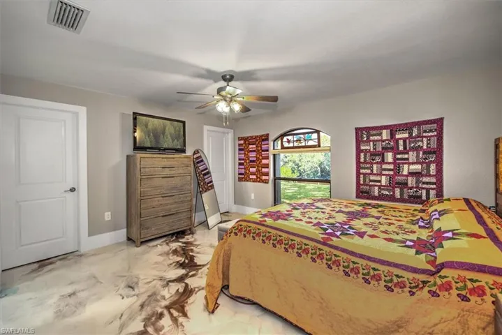 Bedroom featuring a ceiling fan, baseboards, visible vents, and marble finish floor