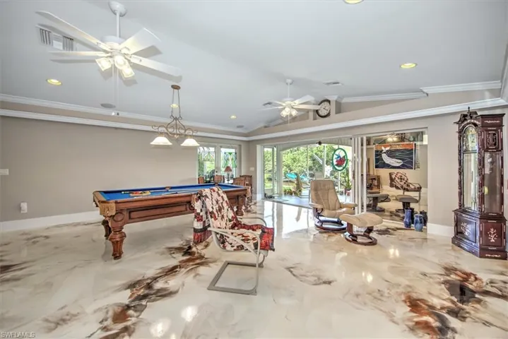 Recreation room featuring visible vents, lofted ceiling, ornamental molding, billiards, and a ceiling fan