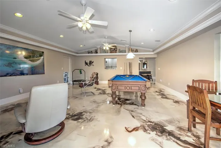 Playroom with marble finish floor, ceiling fan, pool table, and vaulted ceiling