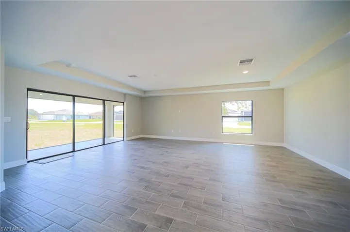 Oversized Living Room And Dining Area With Triple Sliders That Lead Out To Covered And Screened Lanai!