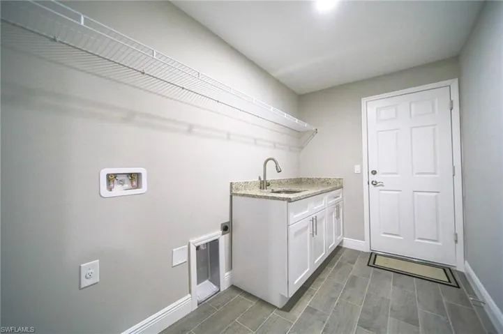Oversized Laundry Room With Cabinets And Shelving!