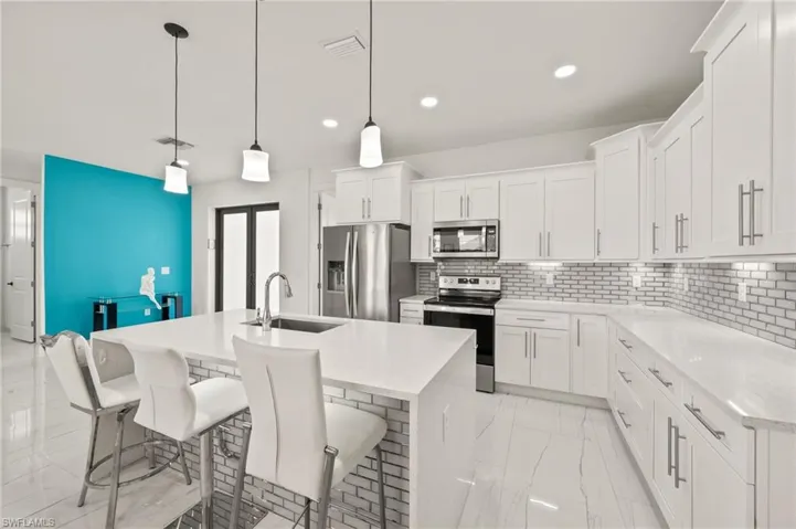 Gorgeous Kitchen with Stainless Steel Appliances and Quartz Countertops