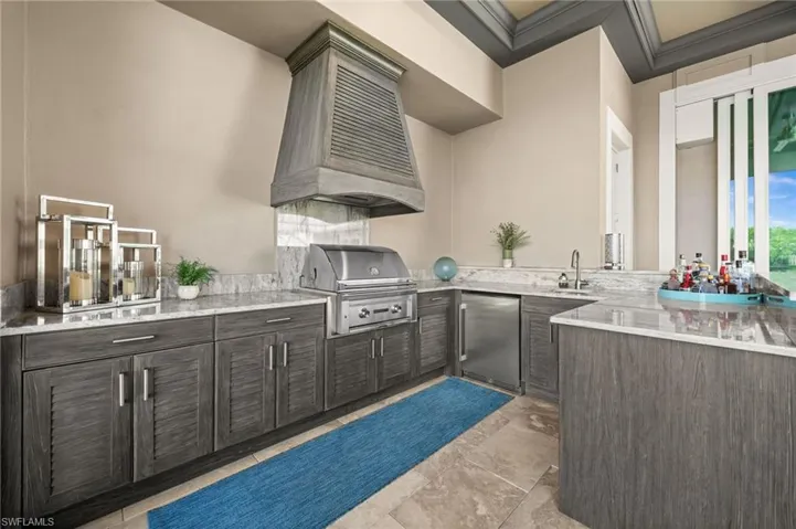 View of patio with exterior kitchen and a sink