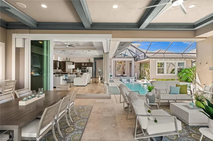 Living room featuring a ceiling fan, beamed ceiling, recessed lighting, and coffered ceiling