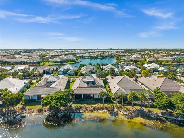 Aerial view of residential area featuring a nearby body of water