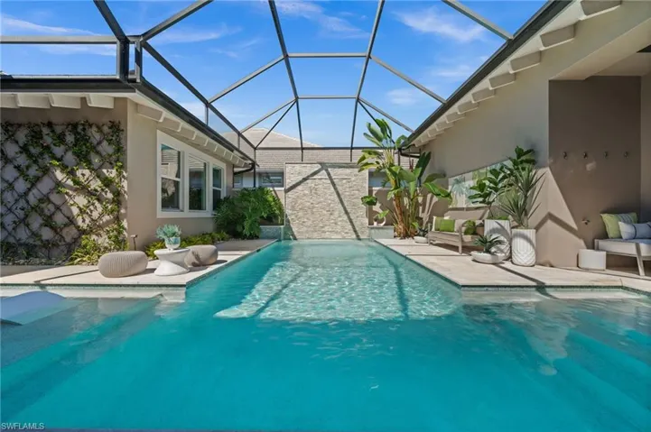 Swimming pool featuring a lanai, a patio, and a sunroom