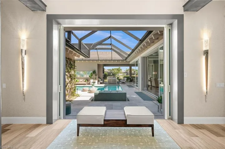 View of patio / terrace with a sunroom, an outdoor pool, and glass enclosure