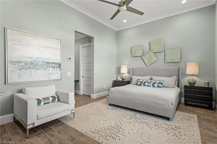 Bedroom with ornamental molding, wood finished floors, a ceiling fan, and recessed lighting