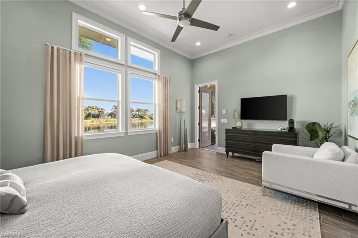 Bedroom with multiple windows, crown molding, a ceiling fan, wood finished floors, and recessed lighting