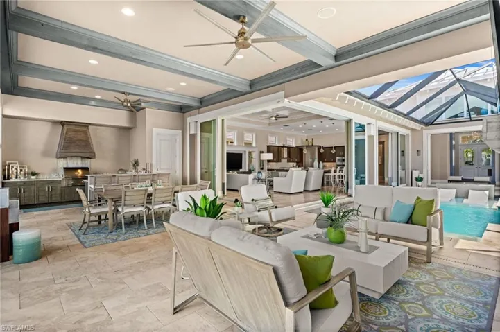 View of patio with outdoor dining space, ceiling fan, outdoor lounge area, an outdoor kitchen, and a lanai