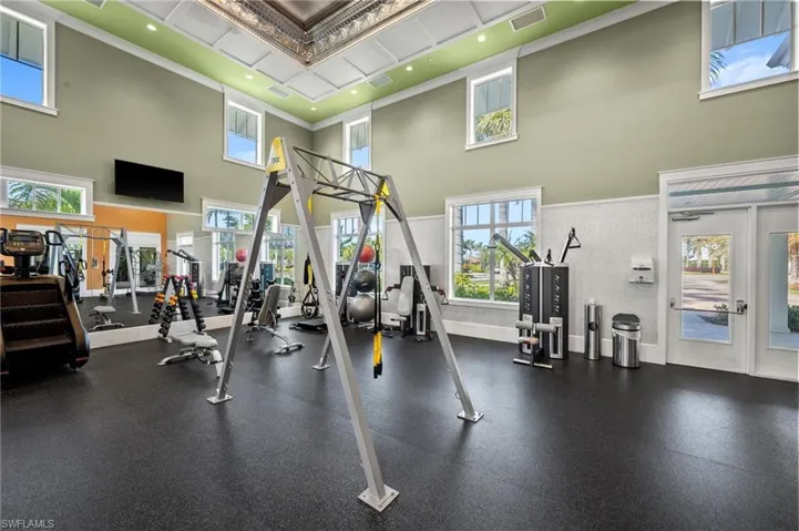 Workout area with crown molding, a high ceiling, and recessed lighting