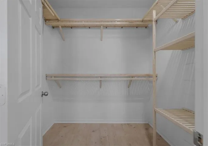 Spacious closet featuring light wood-type flooring