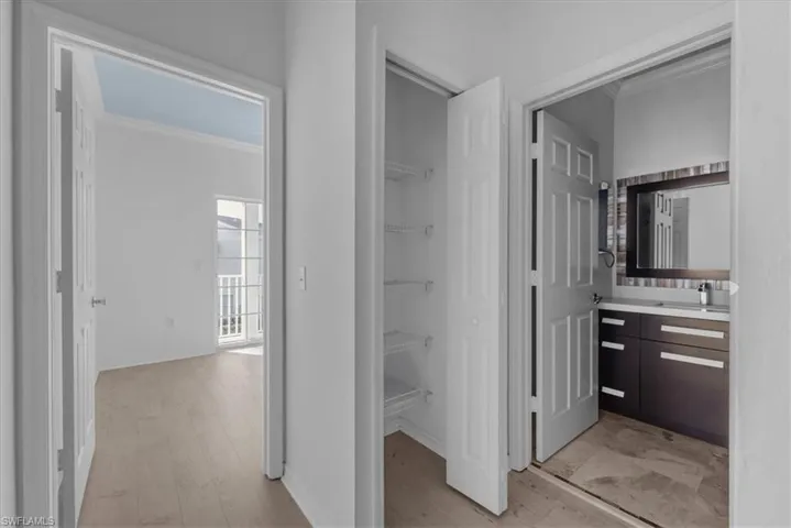 Bathroom featuring vanity, hardwood / wood-style flooring, and crown molding
