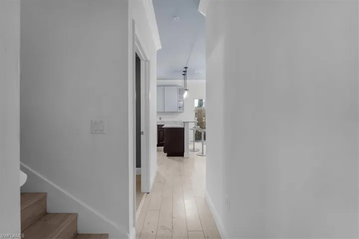 Hall with light hardwood / wood-style flooring