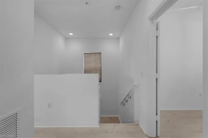 Stairway featuring hardwood / wood-style flooring