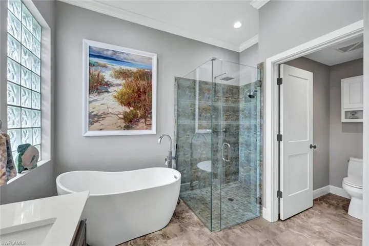 Full bathroom with a healthy amount of sunlight, toilet, and plus walk in shower