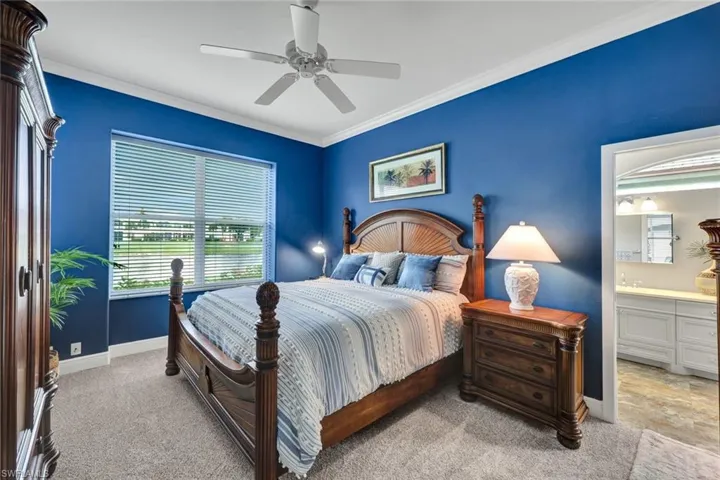Bedroom with connected bathroom, ceiling fan, light tile floors, and crown molding
