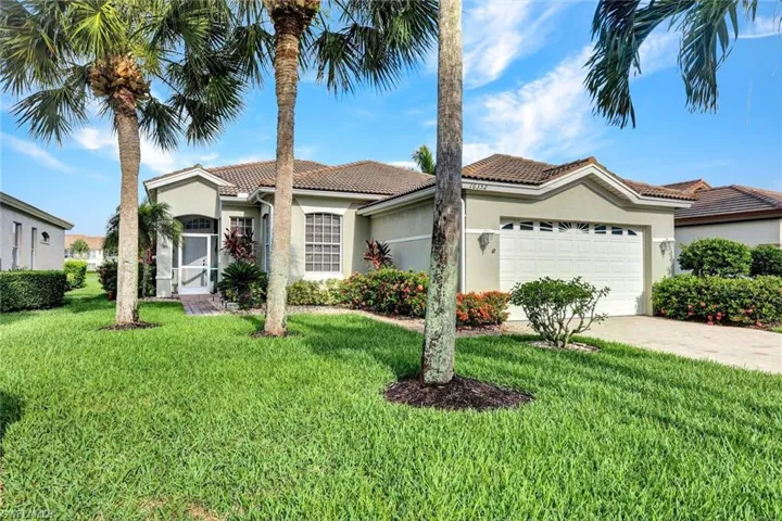 Mediterranean / spanish house featuring a front lawn and a garage