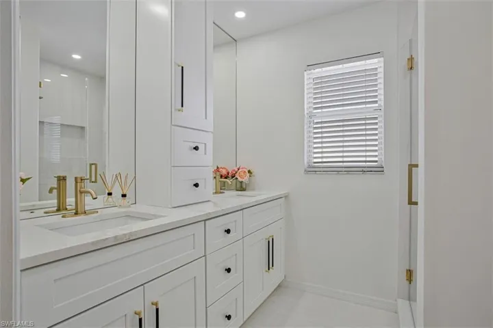 Bathroom with double vanity and recessed lighting