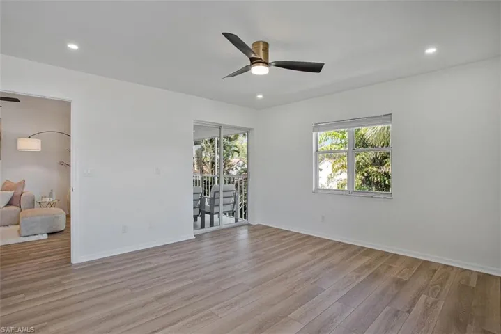 Empty room featuring ceiling fan, light wood-style flooring, and recessed lighting