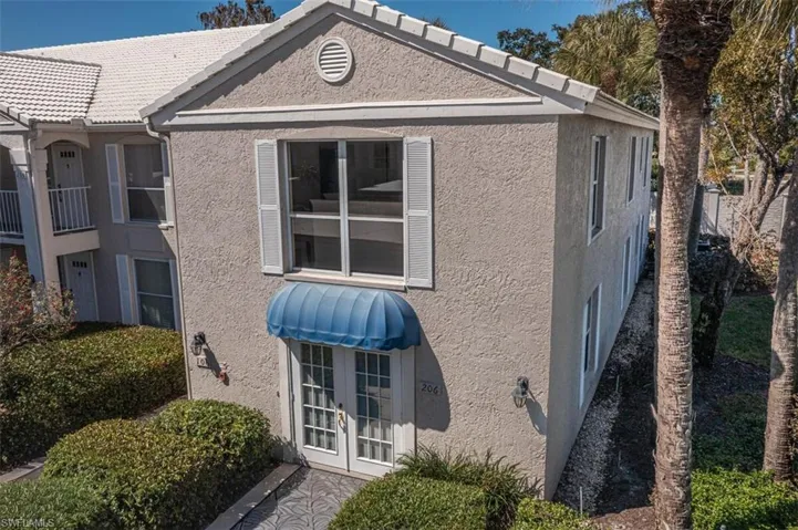 View of home's exterior featuring french doors and stucco siding