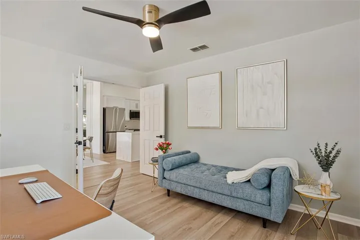 Office area featuring light wood-style floors and ceiling fan