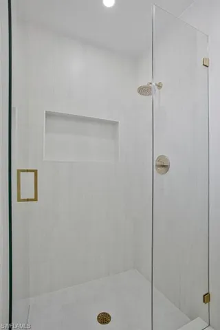 Bathroom with a stall shower and recessed lighting