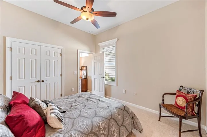 Bedroom featuring a closet, carpet, and ceiling fan