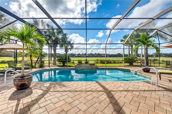 View of swimming pool featuring a patio and a lanai