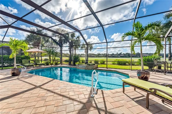 View of swimming pool featuring a patio area and glass enclosure