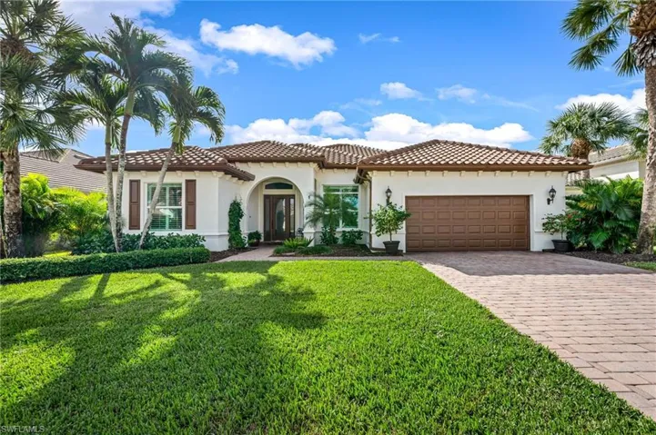 featuring a front lawn and a garage