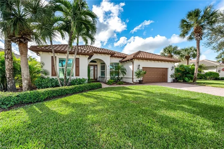 featuring a garage and a front lawn