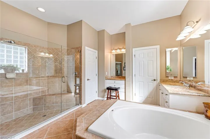 Bathroom with vanity, independent shower and bath, and tile patterned flooring