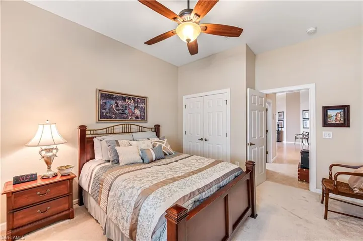 Carpeted bedroom featuring a closet and ceiling fan