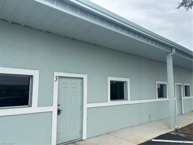 Stucco exterior with a light blue finish and white trim