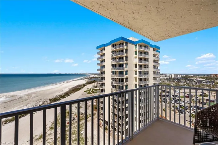 Balcony featuring a beach view and a water view