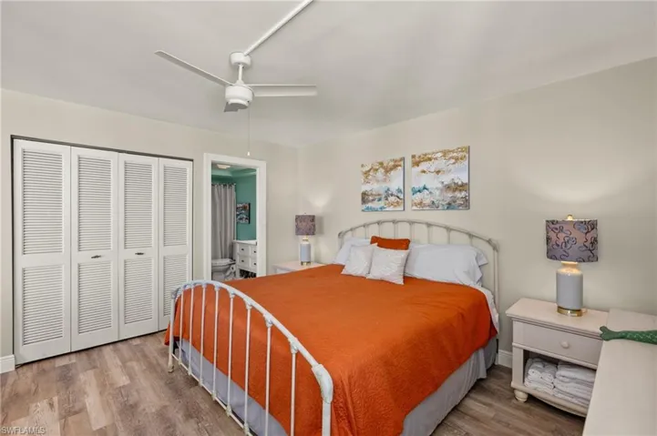 Bedroom featuring ceiling fan, wood-type flooring, and a closet