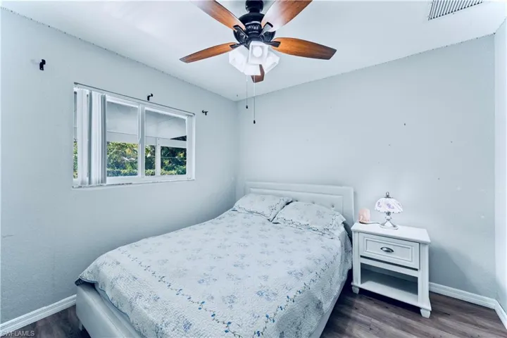 Bedroom with wood finished floors and ceiling fan